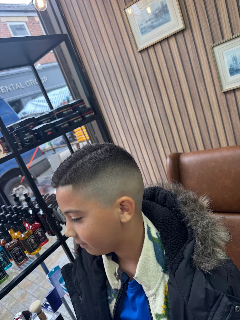 Sharp skin fade haircut inside The Antique Barbers.