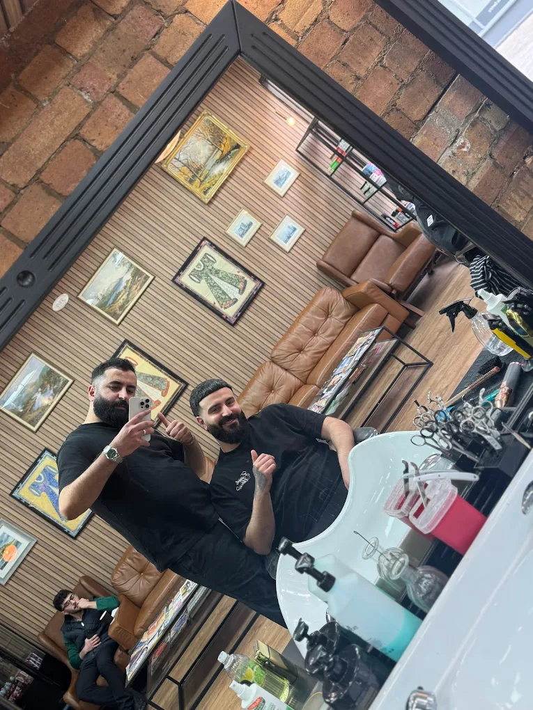 Barbers from The Antique Barbers inside the shop.