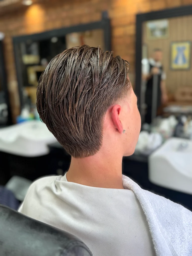 Slick back haircut with precision neckline at The Antique Barbers.